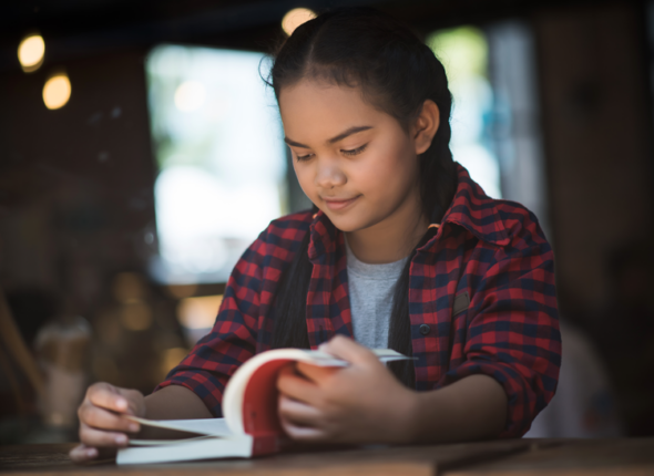 middle schooler reading a book